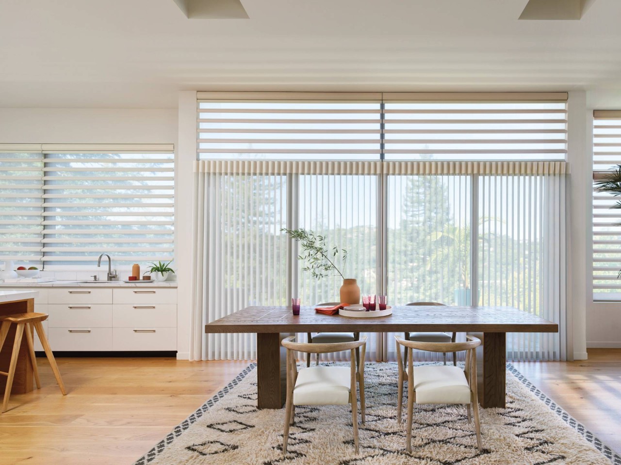 Open dining room with a large window, featuring Hunter Douglas Luminette® Privacy Sheers near Miami, FL