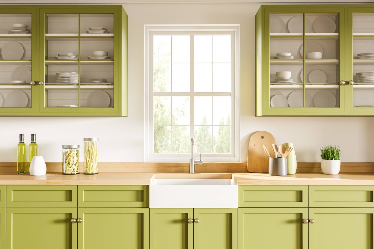 A kitchen sink window without blinds in a fun white and green-themed space with wood countertops at Fine Shadings & Décor near Miami, FL
