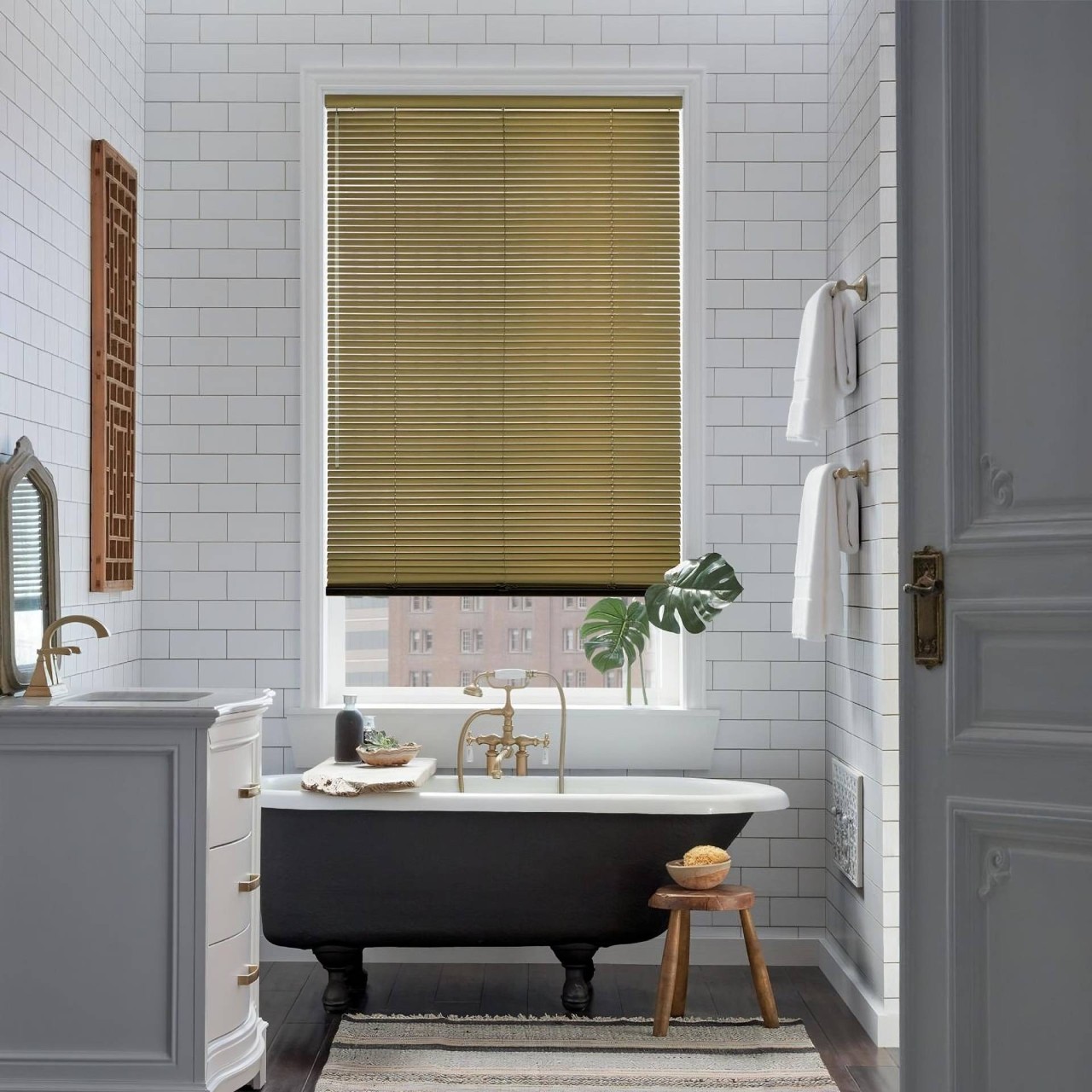 An apartment bathroom with a tall window decorated with Hunter Douglas EverWood® Faux Wood Blinds near Miami, FL