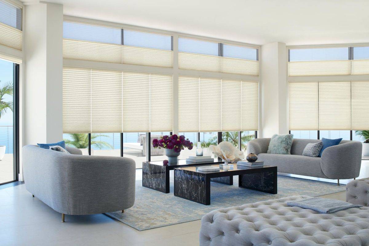 Sun-filled living room with wide windows covered with Hunter Douglas Duette® Cellular Shades  near Miami, FL