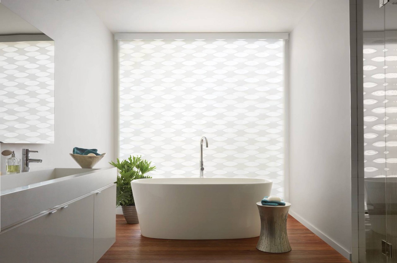 Sleek modern bathroom with a large window covered with Hunter Douglas Designer Banded Shades at Fine Shadings & Décor near Miami, FL